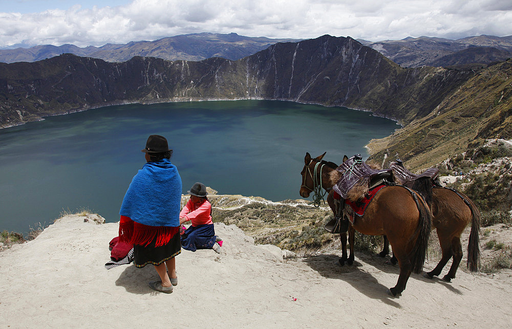 Native people visit the Laguna de Quilotoa crater lake near Latacunga, Ecuador, South America