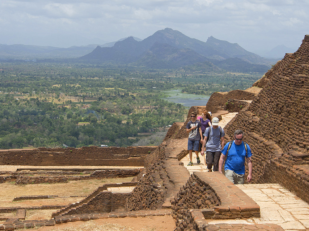 Tourists visit the ancient city of Sigiriya, with carvings on a rock in a mountain fortress, UNESCO World Heritage Site, Sri Lanka, Asia