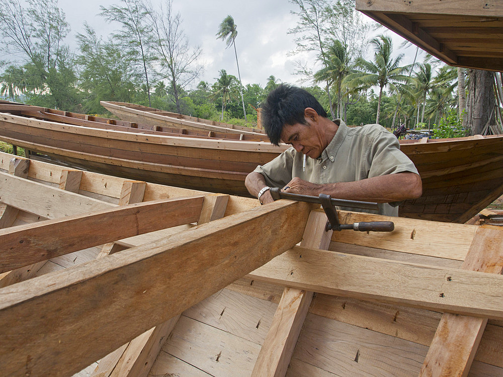 Craftsman making a fishing boat on Bintan island, Sumatra, Indonesia, Southeast Asia, Asia