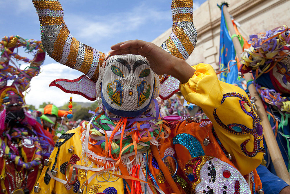 Revellers in costumes and masks at Humahuaca carnival in Jujuy province in the Andes region of Argentina, South America