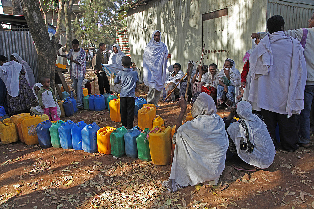 Women queue for water with plastic cans in the outskirts of Addis Ababa, Ethiopia, Africa