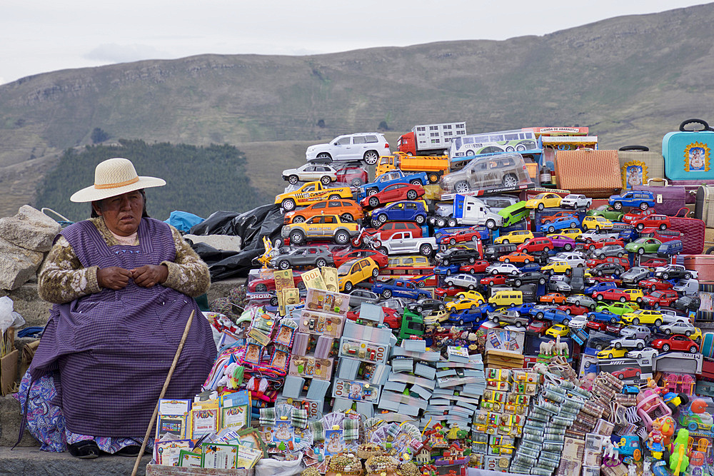 Traditional miniature cars and money thought to give good luck for sale at a stall in the resort of Copacabana on Lake Titicaca, Bolivia, South America