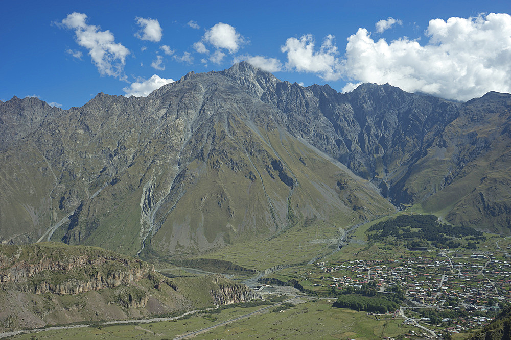 View of the mountains near the Gergeti Holy Trinity Church by the river Chkheri, under Mount Kazbegi at an elevation of 2170 meters in the Caucasus, Georgia, Central Asia, Asia