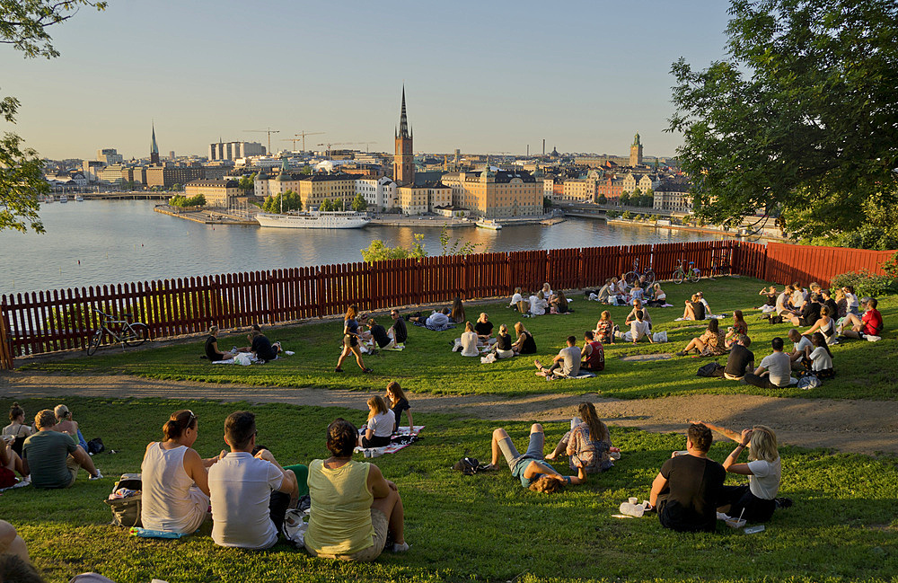 Young people picnic at sunset in the summer in the fashionable Sodermalm neighbourhood and district of Stockholm, Sweden, Scandinavia, Europe