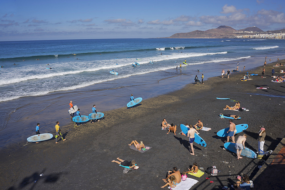 People swimming, surfing, sunbathing and eating on Las Canteras beach in Las Palmas, Gran Canaria, Canary Islands, Spain, Atlantic, Europe