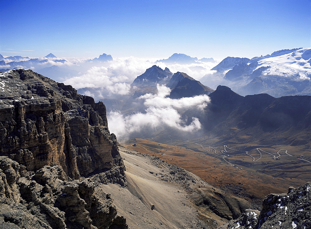 View southeast from top of Sella Group to Passo Pordoi road in valley, Dolomites, Trentino-Alto Adige, Italy, Europe