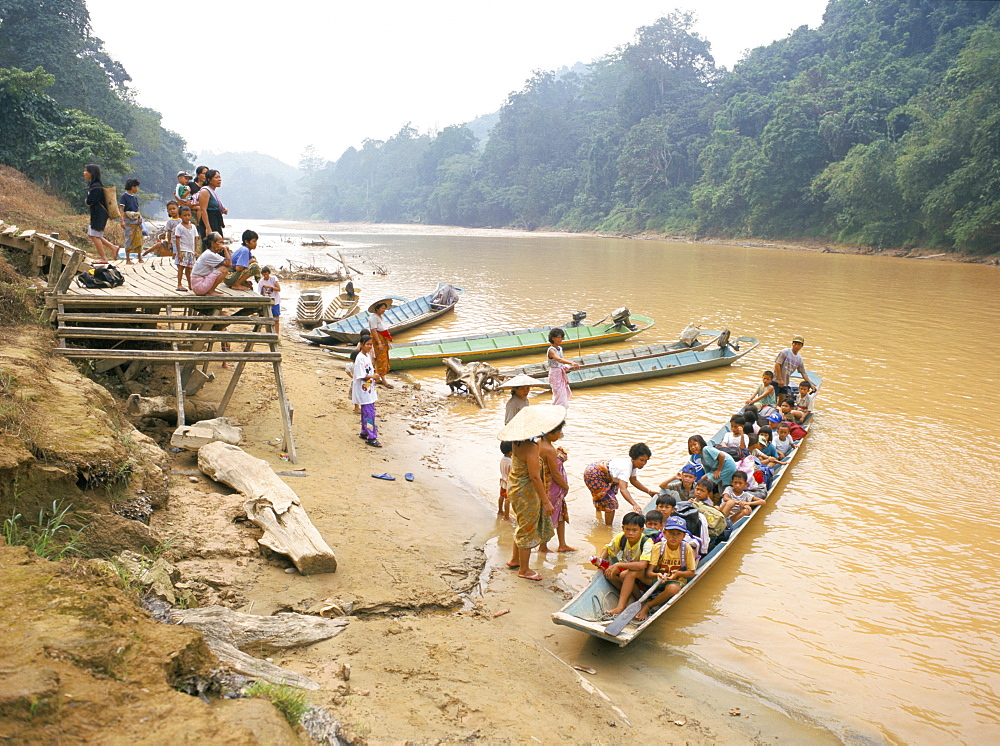 Longboat crowded with children leaving for week at school, seen off by their mothers, Katibas River, Sarawak, island of Borneo, Malaysia, Southeast Asia, Asia