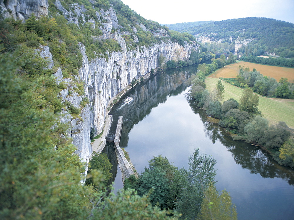 River Lot, with tour boat emerging from lock, near St. Cirq-Lapopie, east of Cahors, Midi-Pyrenees, France, Europe