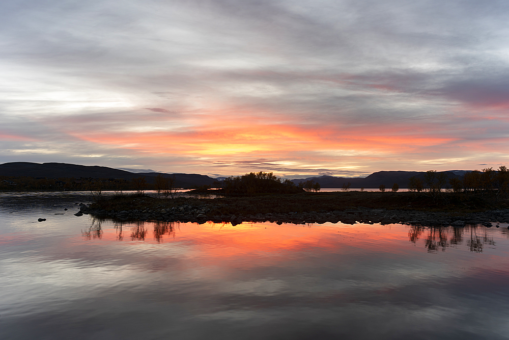 Lake reflection on Lake Kilpis at dusk, Kilpisjarvi, Lapland, Finland, Europe