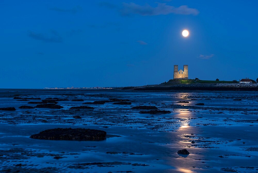 Full moon rising over Reculver Towers, beach at low tide, Reculver, Herne Bay, Kent, England, United Kingdom, Europe