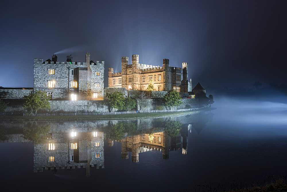 Leeds Castle illuminated in evening mist, winter, near Maidstone, Kent, England, United Kingdom, Europe