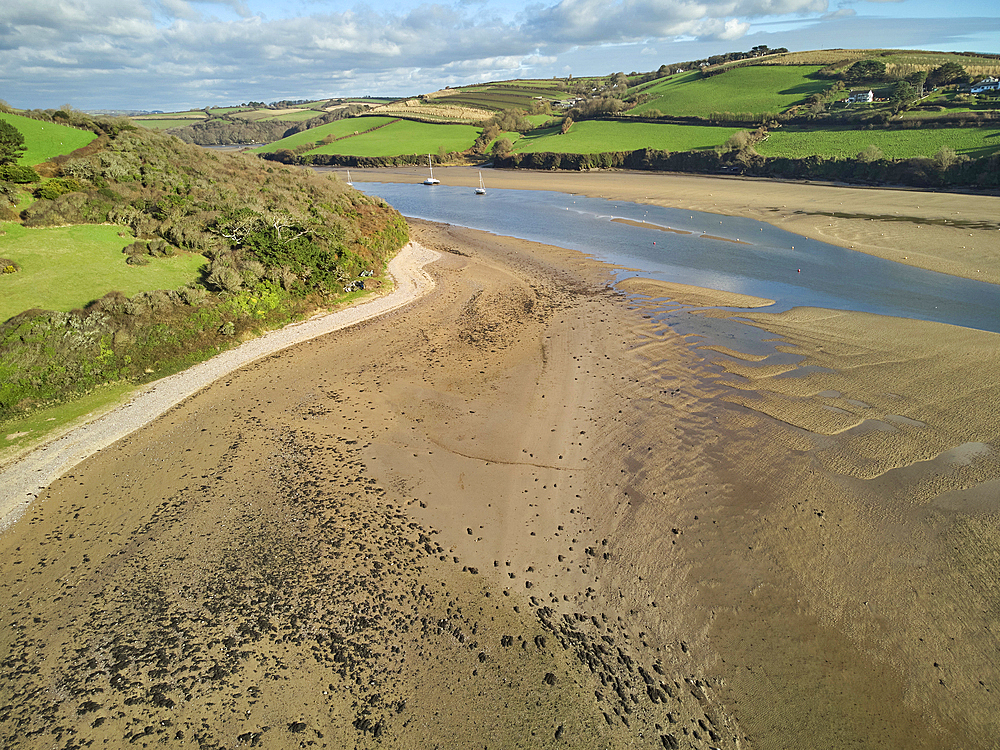 A low tide aerial drone view of the sandy shore and sand banks in the estuary of the River Avon, at Bantham, on the south coast of Devon, Great Britain.