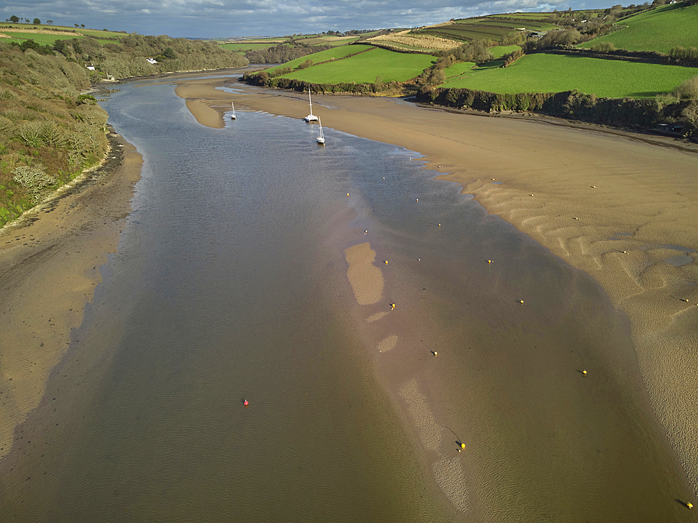 A low tide aerial drone view of the sandy shore and sand banks in the estuary of the River Avon, at Bantham, on the south coast of Devon, Great Britain.