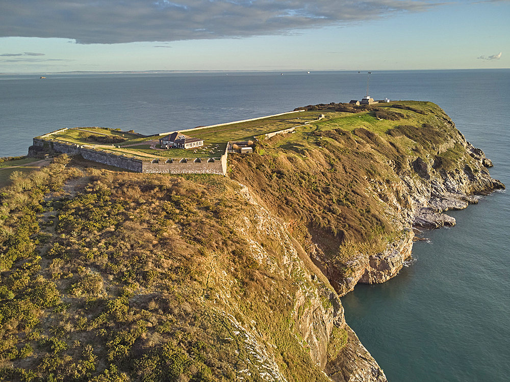 An early morning view of the cliffs at Berry Head, the southernmost point of Torbay, with one of two Napoleonic era forts on the headland, at Brixham, Torbay, Devon, Great Britain.