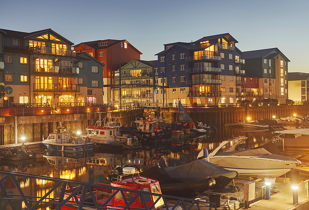 A dusk view of the harbour and surrounding apartments at Exmouth, on the coast of Devon, Great Britain.