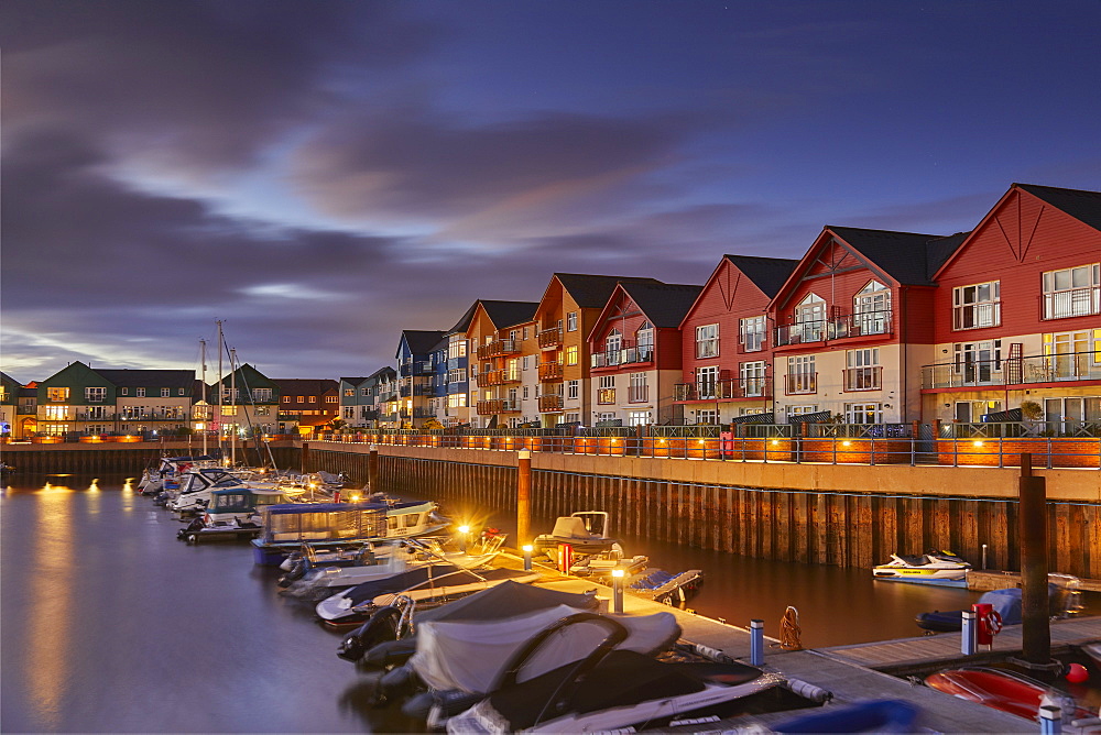 A dusk view of the marina and modern apartments in the revamped dock at Exmouth, on the south coast of Devon, England, United Kingdom, Europe