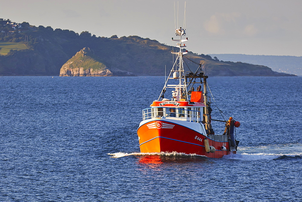 A fishing boat returns to port after a hard day at sea, Brixham, the southwest's busiest fishing harbour, Devon, England, United Kingdom, Europe