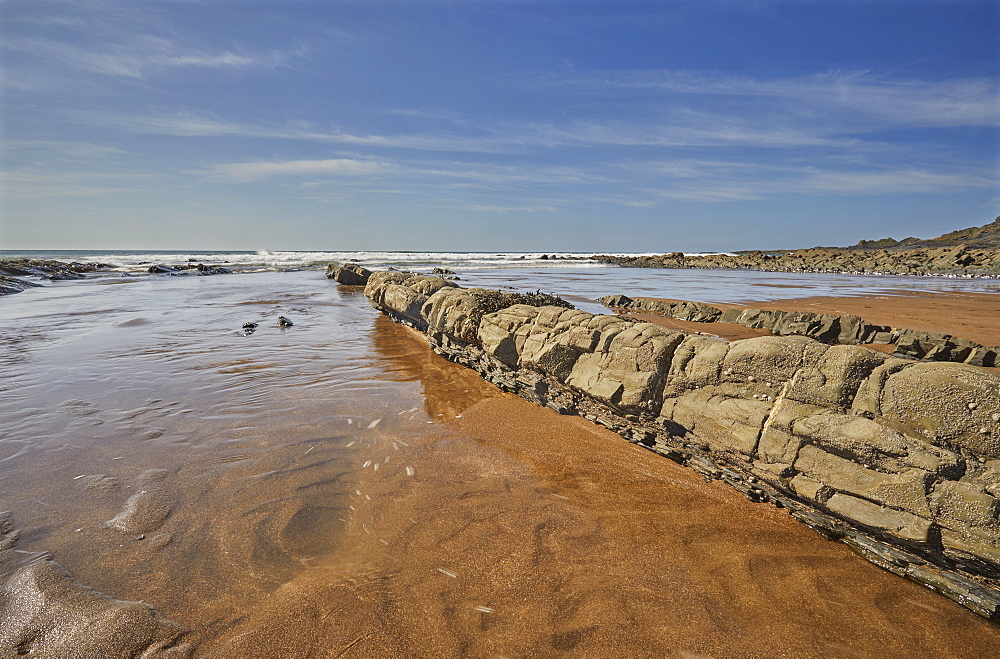 The dramatic mixed sand and rocks of the beach at Speke's Mill Mouth, on Devon's Atlantic coast, near Hartland Quay, Devon, England, United Kingdom, Europe