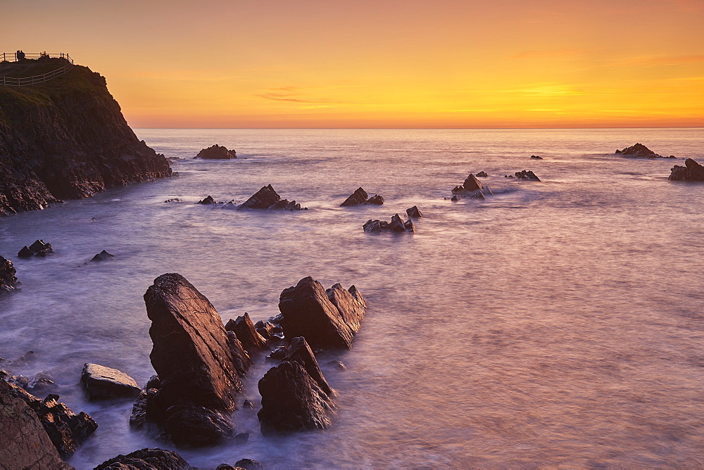 The cliffs and rocks of Devon's Atlantic coast, at Hartland Quay, seen during a calm evening sunset, Devon, England, United Kingdom, Europe