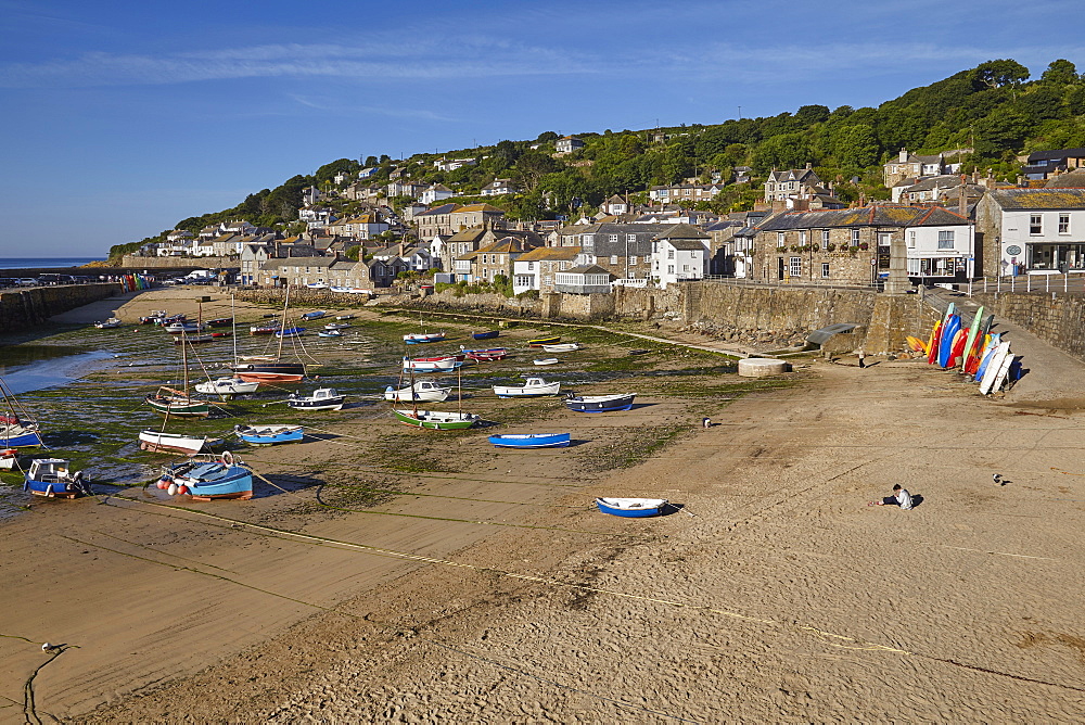 The harbour at Mousehole, an historic and archetypal Cornish fishing village, seen at low tide, near Penzance, west Cornwall, England, United Kingdom, Europe