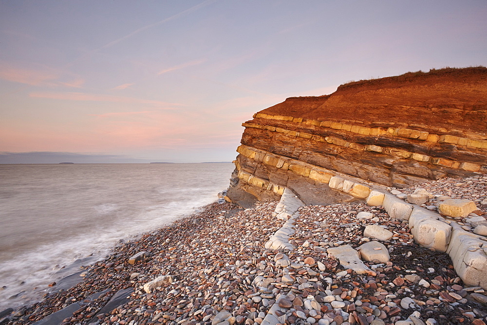 Evening light on rocks and the cliff at Kilve beach, Kilve, near Nether Stowey, Somerset, England, United Kingdom, Europe