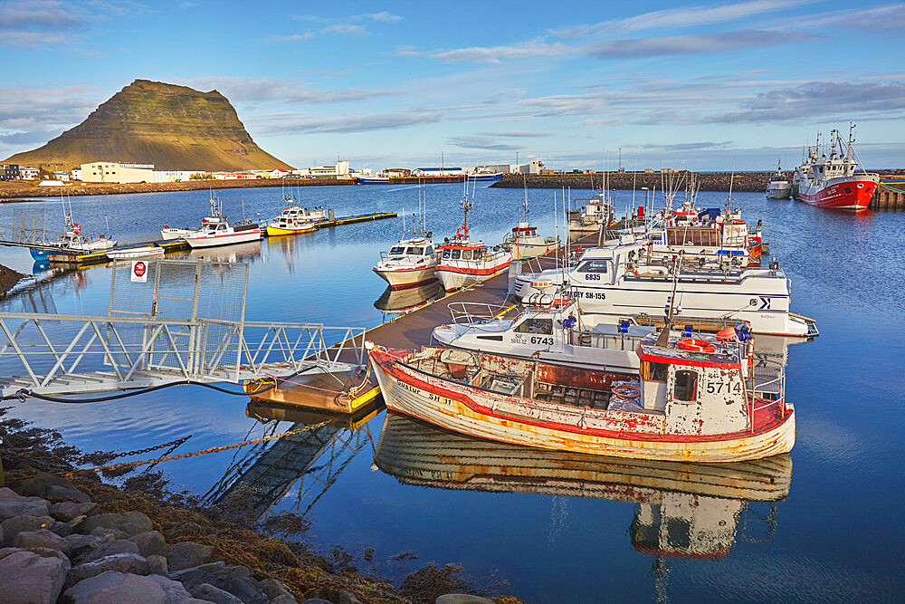 A fishing boat in the harbour at Grundarfjordur, with Mount Kirkjufell as a backdrop, on the Snaefellsnes peninsula, west Iceland, Polar Regions