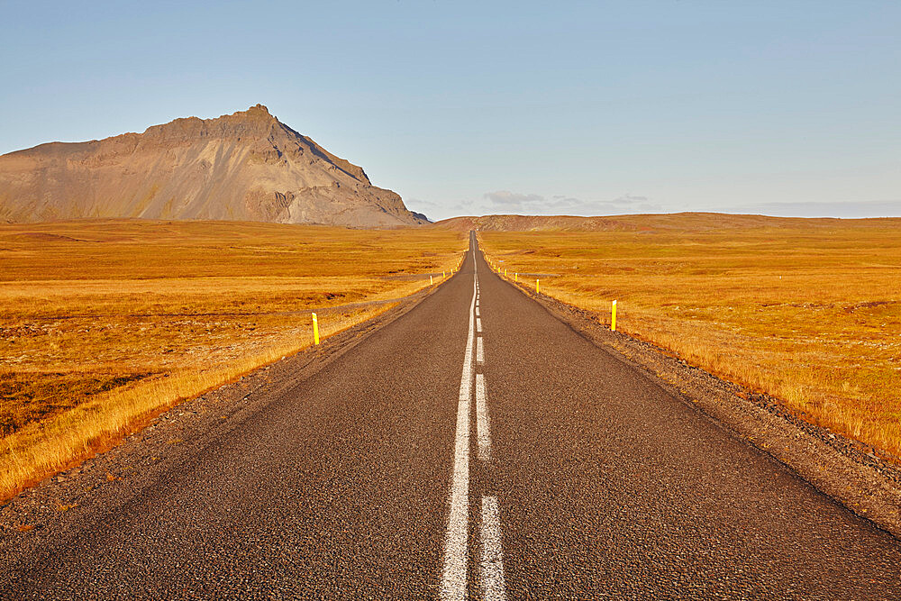 An arrow-straight road cuts across a lava field in Snaefellsjokull National Park, Snaefellsness peninsula, western Iceland, Polar Regions