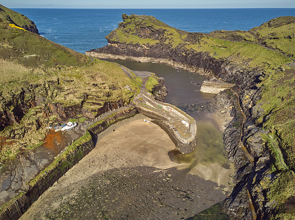 An aerial view of the narrow harbour and surrounding cliffs at Boscastle, on the Atlantic coast of north Cornwall, England, United Kingdom, Europe