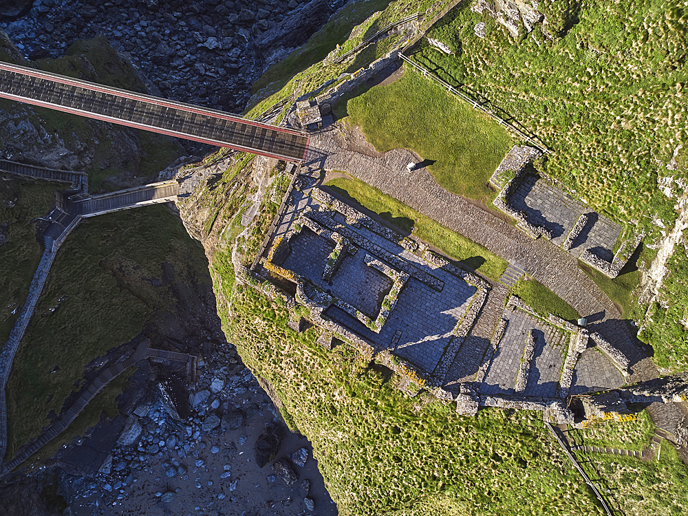 An aerial view of the dramatic ruins of Tintagel Castle, said to be the birthplace of King Arthur, on a rocky island off the shore, near the town of Tintagel, Cornwall, England, United Kingdom, Europe