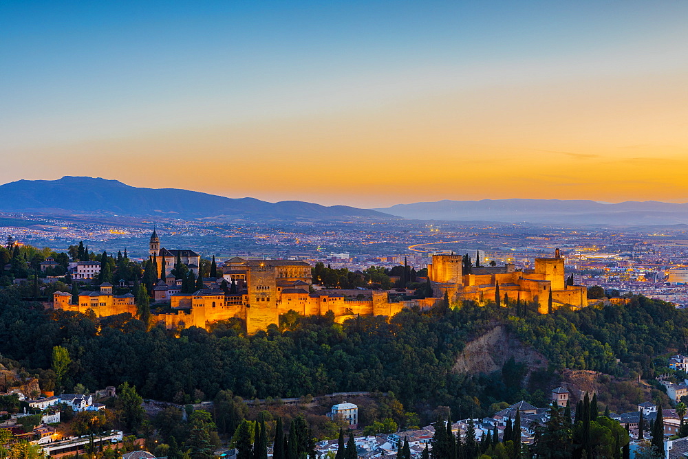 View of Alhambra, UNESCO World Heritage Site, and Sierra Nevada mountains at dusk, Granada, Andalucia, Spain, Europe