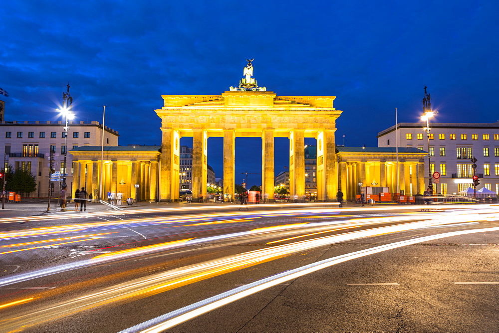 Light trails by Brandenburg Gate at night in Berlin, Germany, Europe