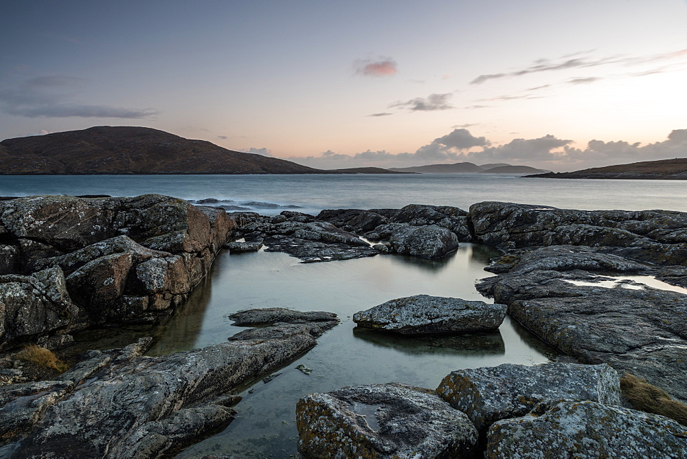 Bagh a Deas (South Beach), with Sandray, Pabbay, Mingulay and Berneray in far distance at sunset, Vatersay, Outer Hebrides, Scotland, United Kingdom, Europe