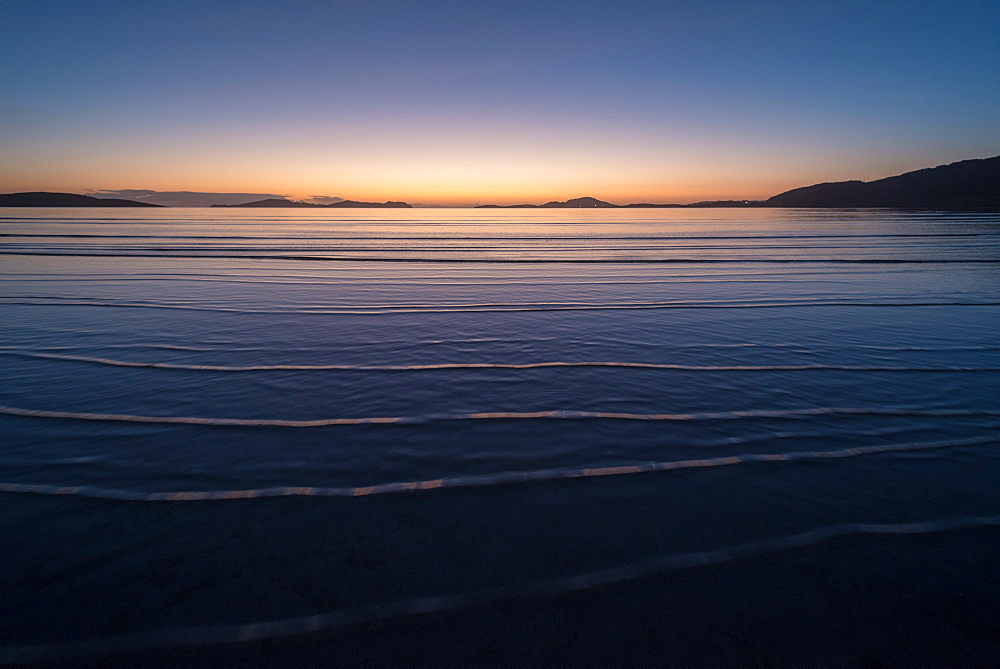 Winter sunrise at high tide, Traigh Mhor, the beach used as Barra Airport at low tide, Barra, Outer Hebrides, Scotland, United Kingdom, Europe