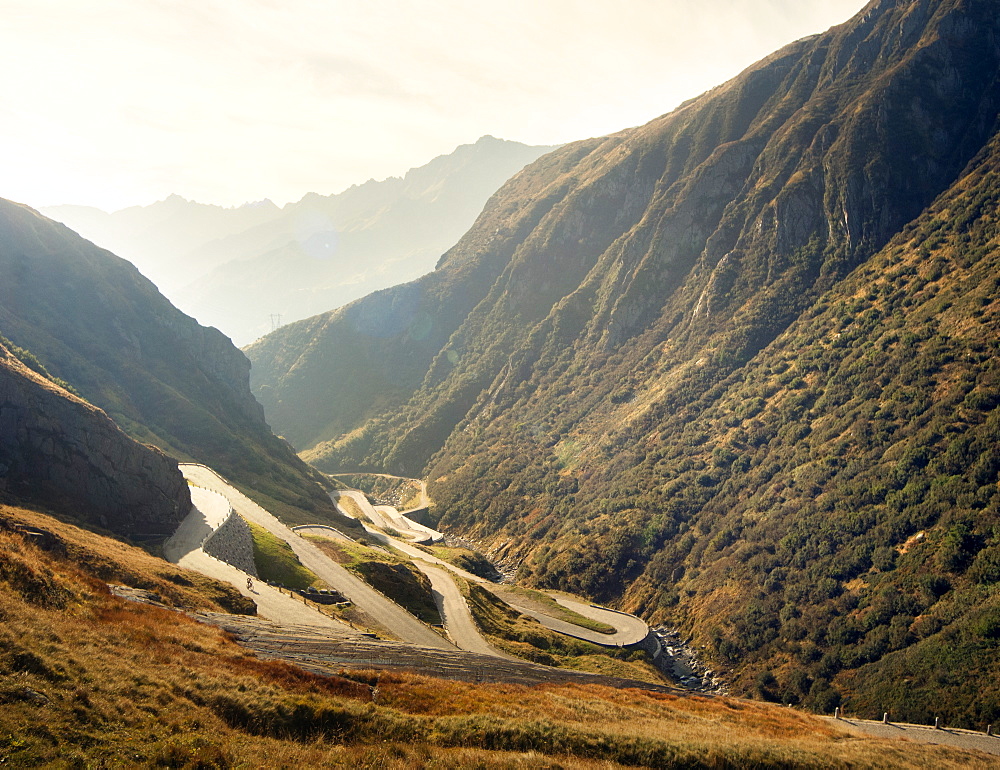 Cyclist on a winding mountain pass, Italy, Europe