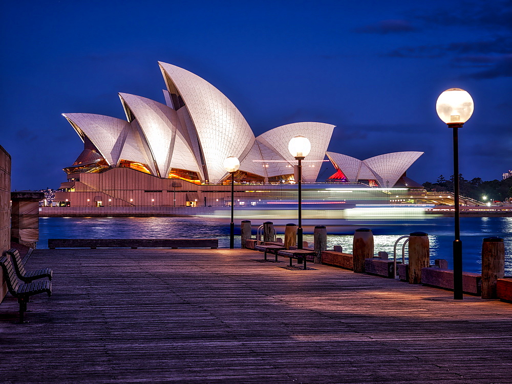 A boat passes by the Sydney Opera House, UNESCO World Heritage Site, during blue hour, Sydney, New South Wales, Australia, Pacific