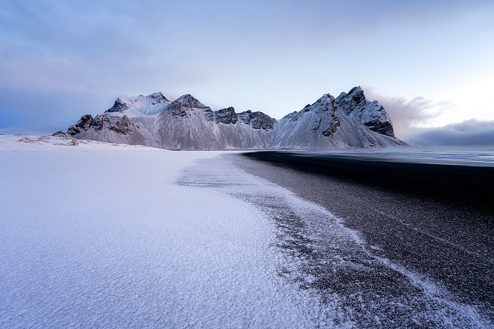 View of the mountains of Vestrahorn from black volcanic sand beach after snowfall, Stokksnes, South Iceland, Iceland, Polar Regions