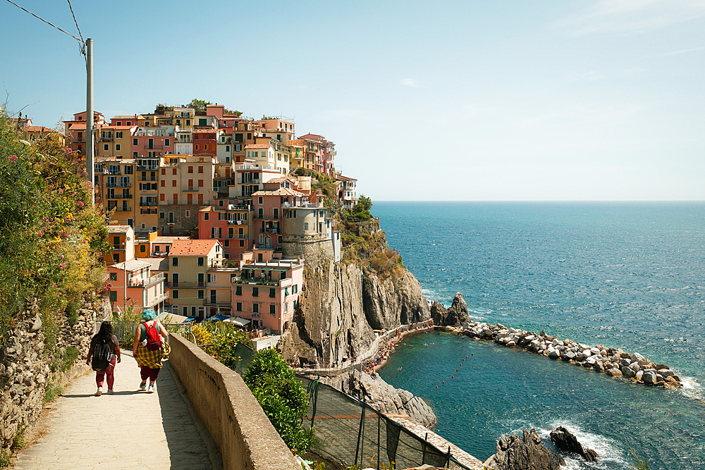 Couple walking in the village of Manarola in Cinque Terre, UNESCO, La Spezia, Italy