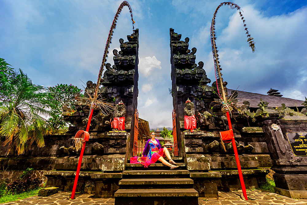 Woman posing for photo at the Besakih Temple, the largest and holiest temple of Hindu religion in Bali, Indonesia, Southeast Asia, Asia