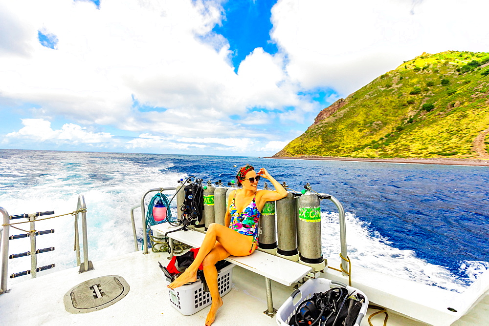 Woman taking in the sights from a boat on the water on Saba Island, Netherlands Antilles, West Indies, Caribbean, Central America