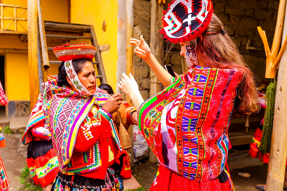 Visitors learning how to weave from the Huilloc weavers, Peru, South America