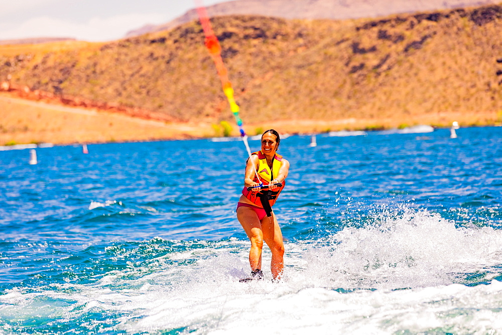 Woman wake boarding at the Sand Hollow Reservoir, Utah, United States of America, North America