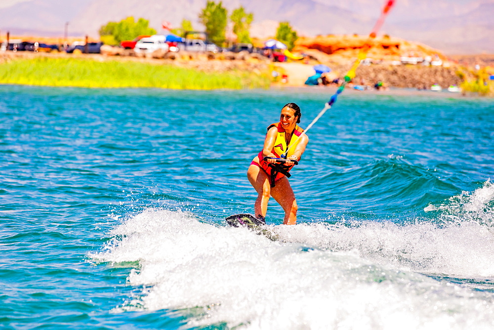 Woman wake boarding at the Sand Hollow Reservoir, Utah, United States of America, North America