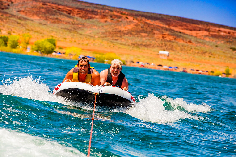 Two friends tubing in Utah, United States of America, North America