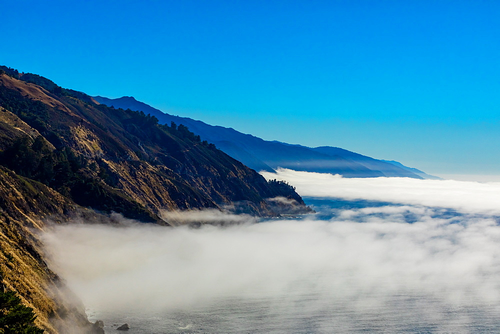 Fog gliding across the sea and up onto Highway 1, California, United States of America, North America