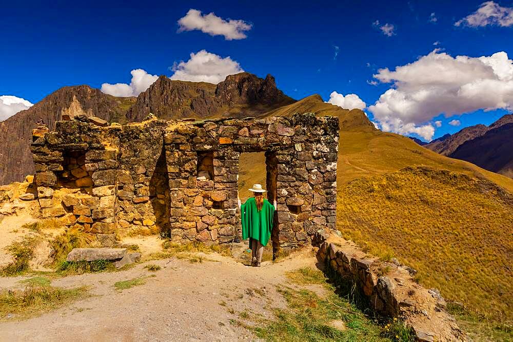 Woman exploring Inti Punku (Sun Gate), Cusco, Peru, South America