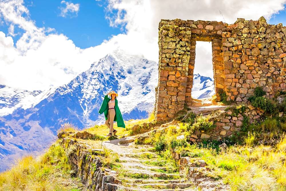 Woman enjoying the view high in the Andes Mountains while exploring Inti Punku (Sun Gate), Cusco, Peru, South America