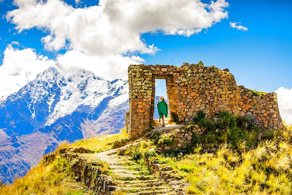 Woman enjoying the view high in the Andes Mountains while exploring Inti Punku (Sun Gate), Cusco, Peru, South America