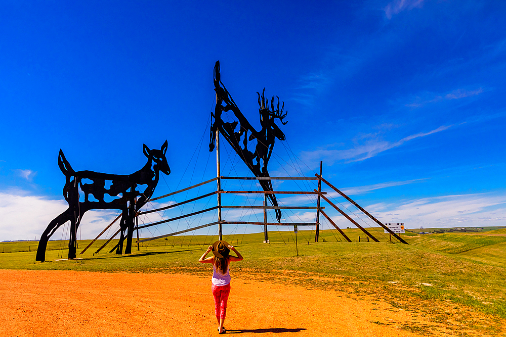 Woman in The Enchanted Highway, a collection of large scrap metal sculptures constructed at intervals along a two-lane highway, North Dakota, United States of America, North America