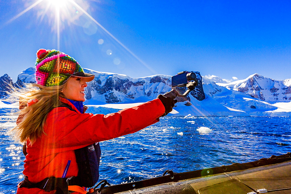 Documenting the scenic view of the glacial ice and floating icebergs in Antarctica, Polar Regions