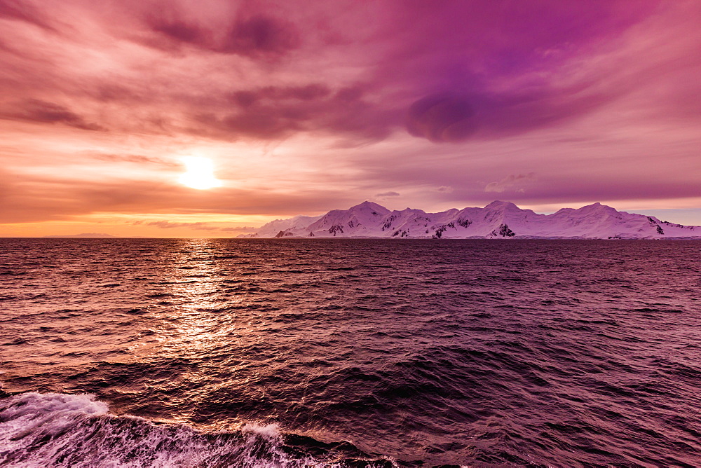 Sunset and a scenic view of the glacial ice and floating icebergs in Antarctica, Polar Regions